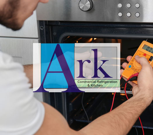 Technician performing maintenance on an oven with Ark Commercial Refrigeration & Kitchen logo overlay